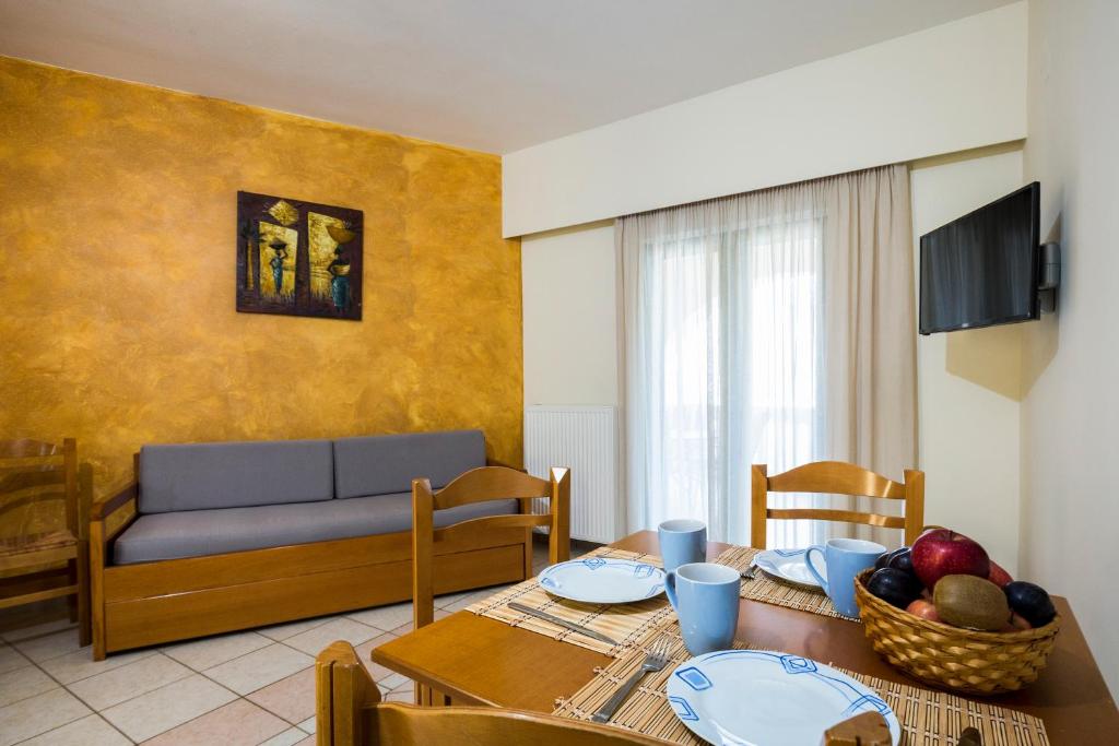 a living room with a table and a couch at Gramvoussa Bay in Kissamos