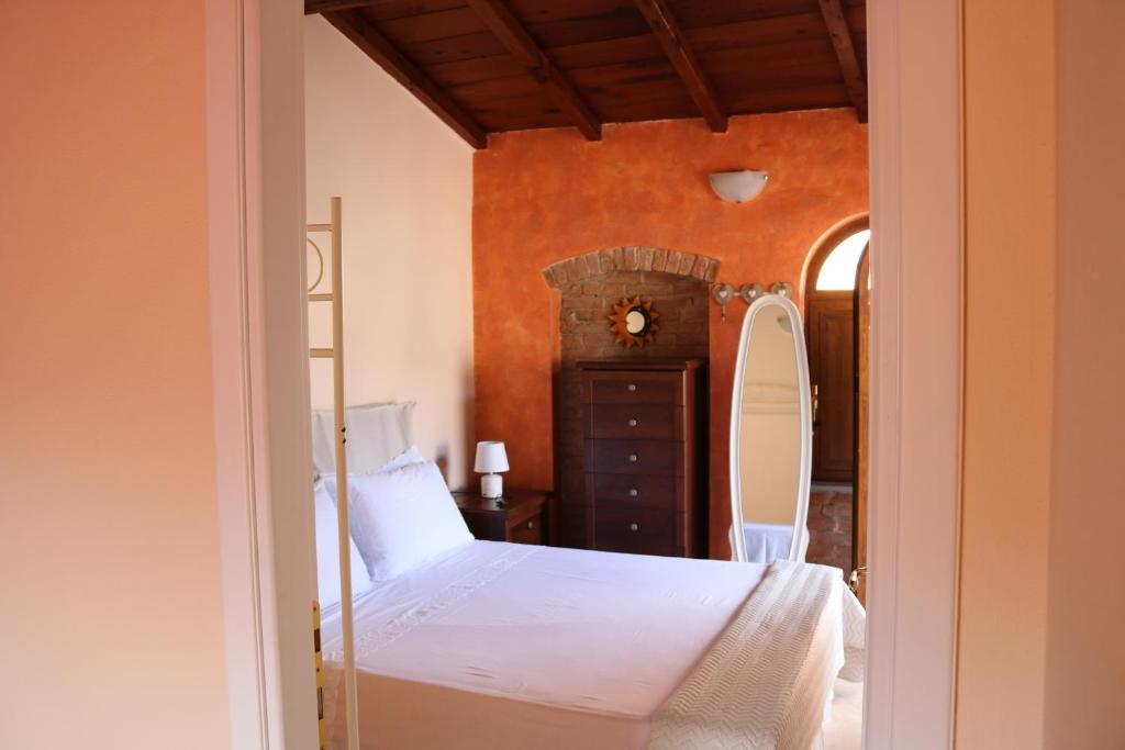 a bedroom with a bed and a dresser and a mirror at Casa vacanze Elena in Rometta