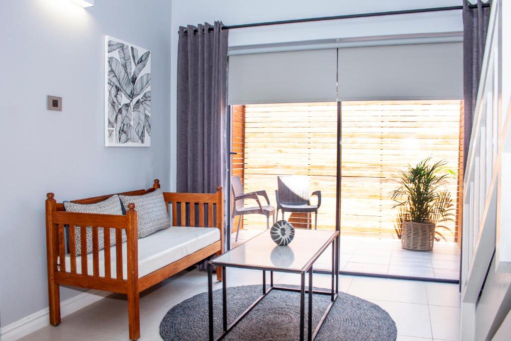 a living room with a couch and a table at Lofts on Lorna in Ballito