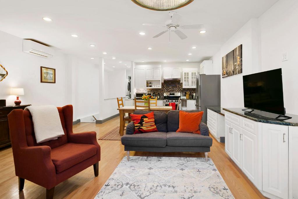 a living room with a couch and a chair at 2-bedroom in Upper West Side, private entrance in New York