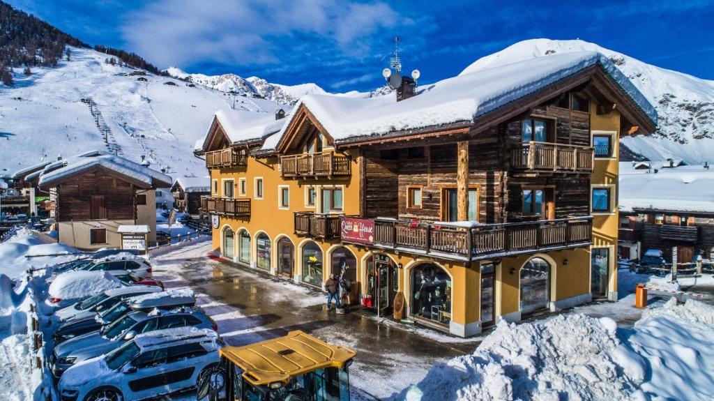 a large wooden building with a snow covered roof at Casa Marisa in Livigno