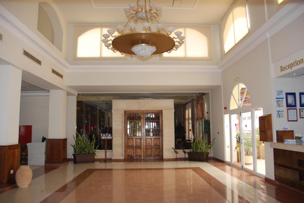 a large lobby with a chandelier in a building at Aktea Beach Village in Ayia Napa