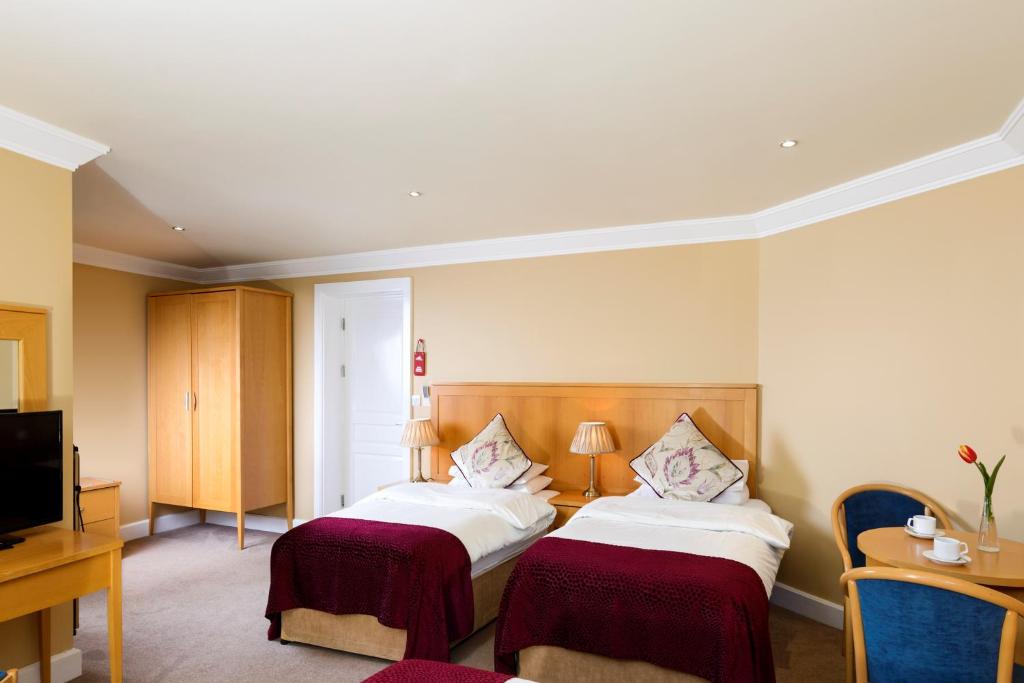 Krevet ili kreveti u jedinici u okviru objekta Dingle Bay Hotel