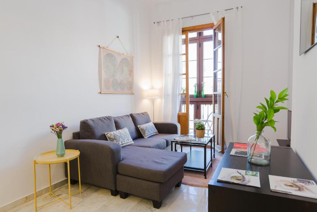 a living room with a couch and a table at Hola Málaga Atarazanas in Málaga