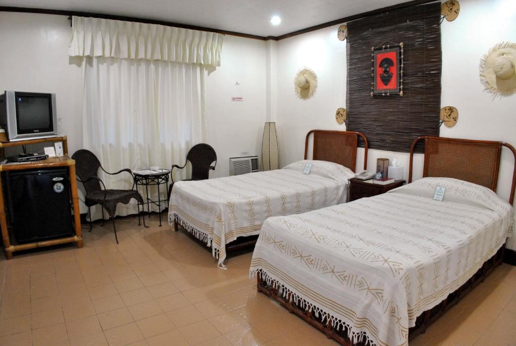 Postel nebo postele na pokoji v ubytování Surfside Boracay Resort