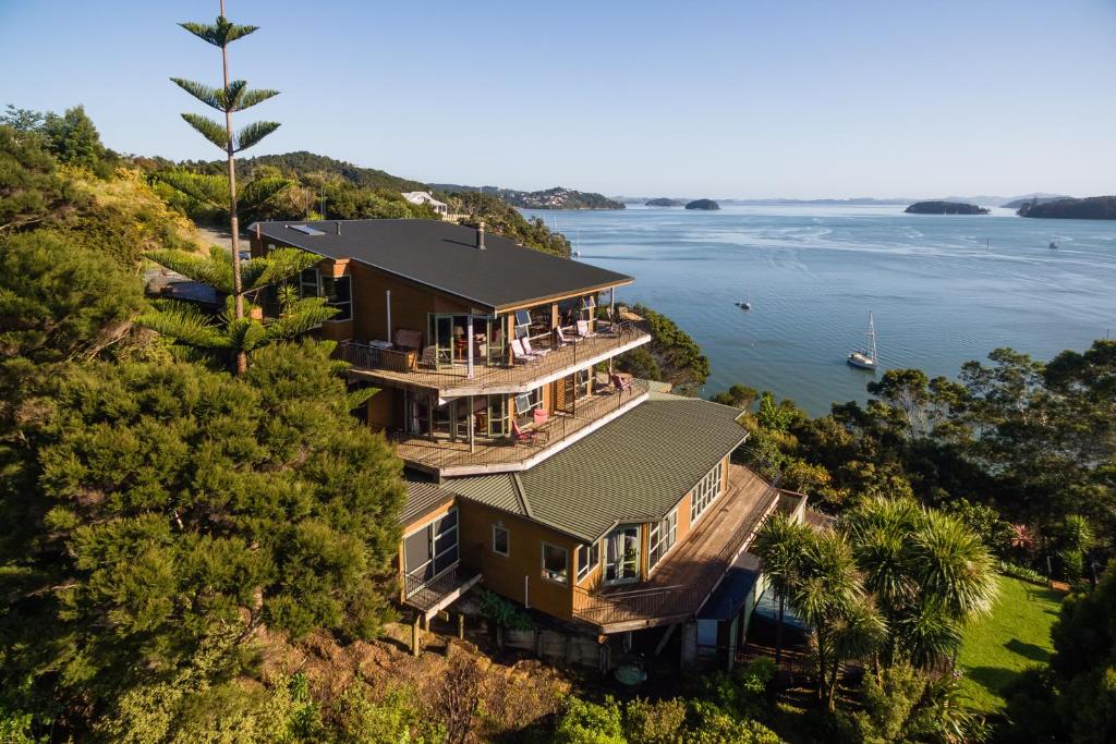 an aerial view of a house on a hill next to the water at Cliff Edge by the Sea in Paihia
