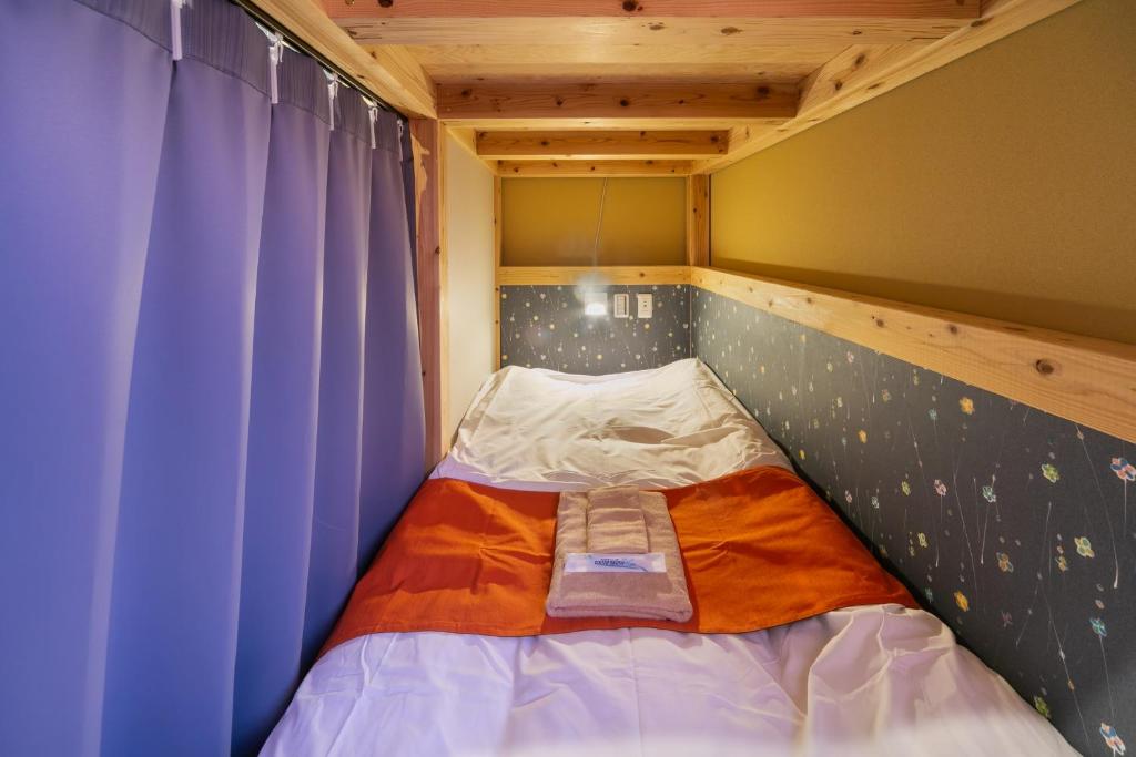 Postel nebo postele na pokoji v ubytování IKIDANE Cozy Hotel Haneda Airport