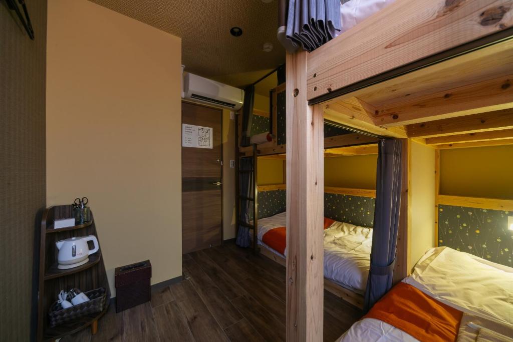 Postel nebo postele na pokoji v ubytování IKIDANE Cozy Hotel Haneda Airport