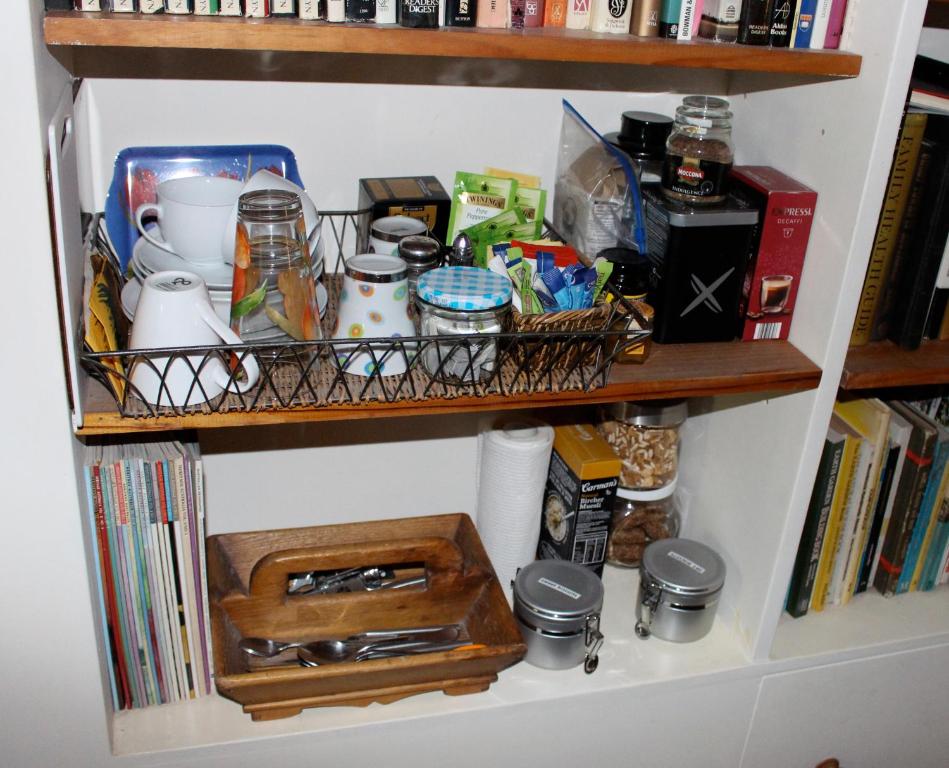a book shelf with food and other items on it at Borough B&B in Eaglehawk