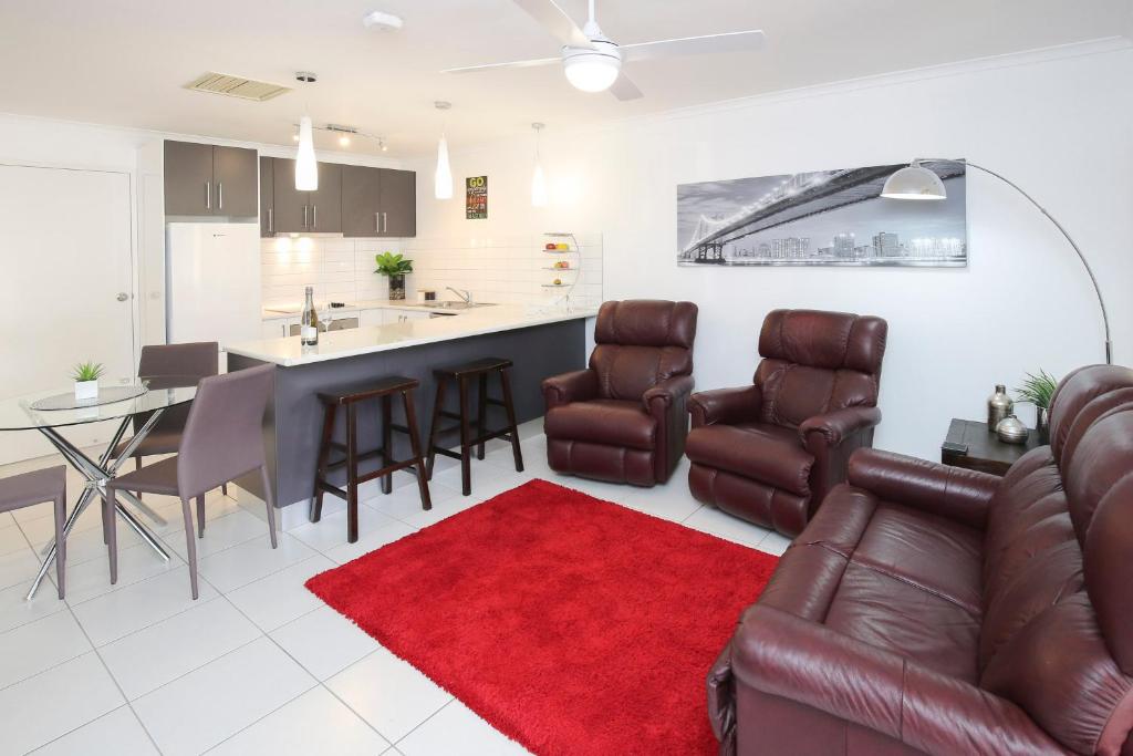 a living room with a couch and a red rug at Allure Apartments - Central in Mildura