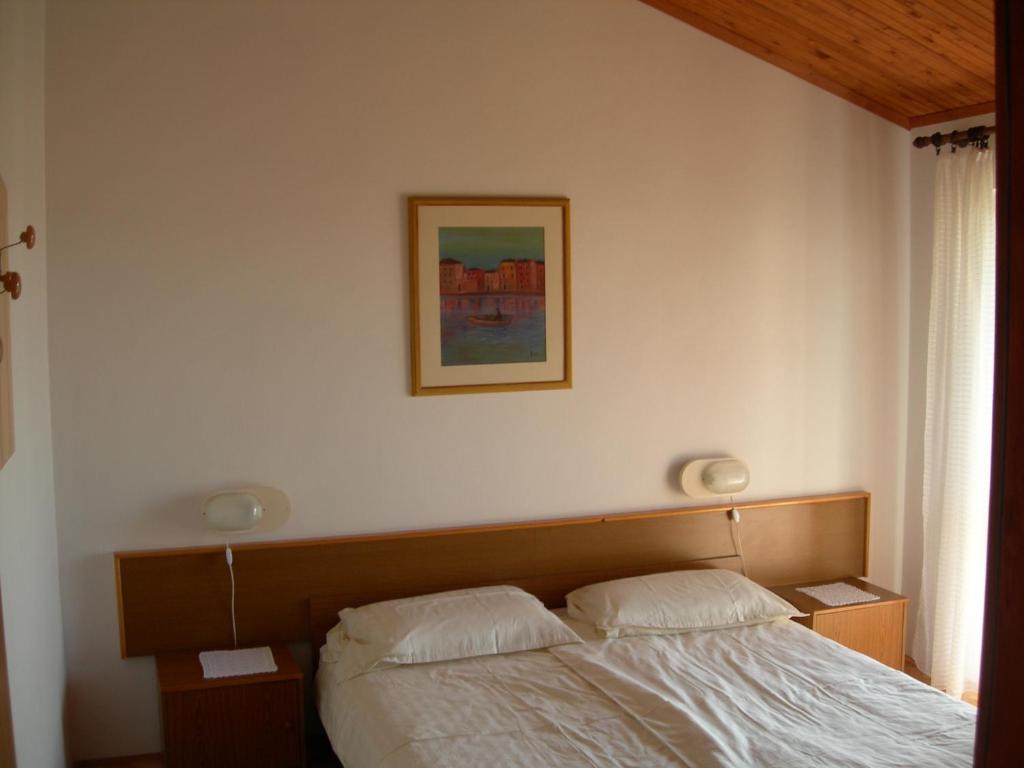 Postel nebo postele na pokoji v ubytování Apartments Nadija