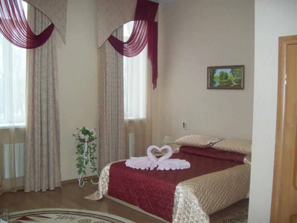 a bedroom with two beds with a towel on the bed at Levyi Bereg in Ulyanovsk