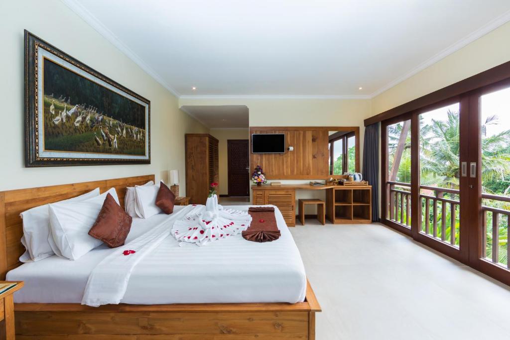 Postel nebo postele na pokoji v ubytování Alamdini Resort Ubud