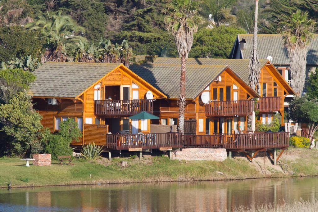 a wooden house with a large deck on the water at ON the Water @ Pirates Creek #8 in Wilderness