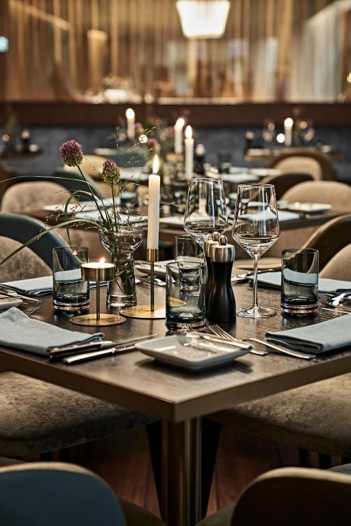 a table in a restaurant with wine glasses on it at SIDE, Hamburg, a Member of Design Hotels in Hamburg