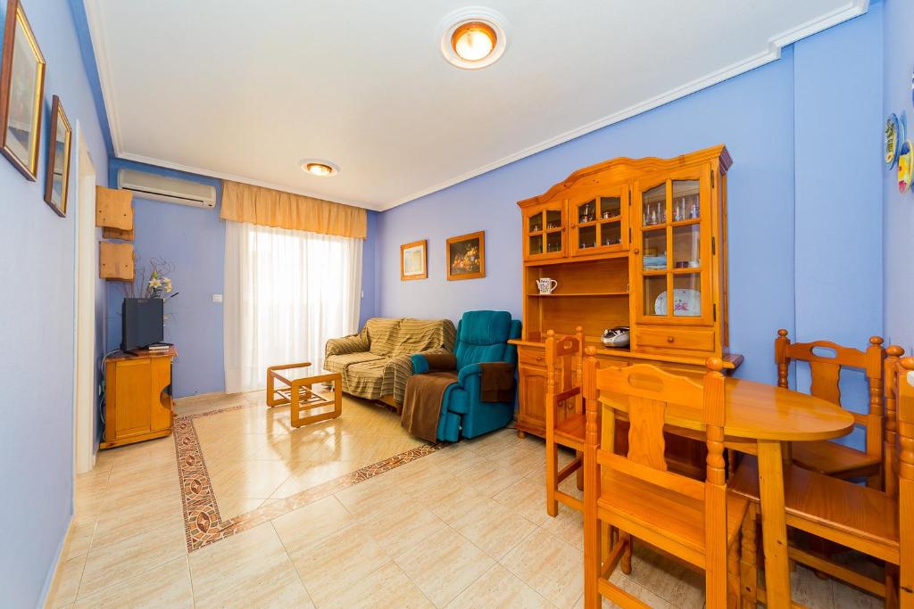 a living room with a table and a couch at ALEGRIA ID118 in Torrevieja