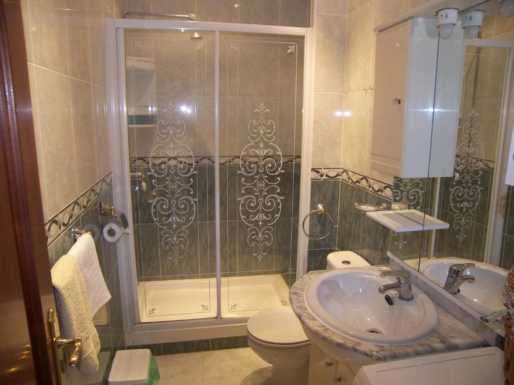 a bathroom with a shower and a toilet and a sink at Nerja Villas-Capistrano in Nerja
