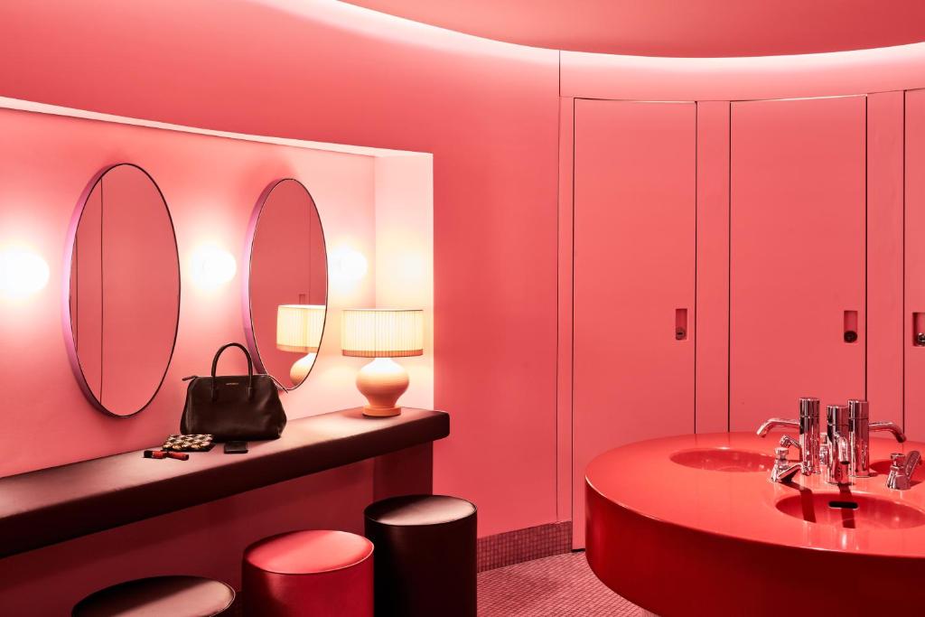 a bathroom with a sink and a mirror at SIDE Design Hotel Hamburg in Hamburg