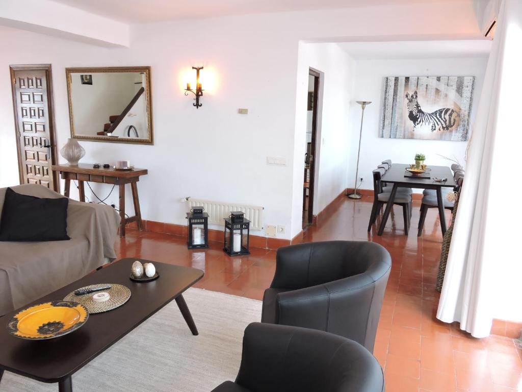 a living room with a couch and a table at Nerja Villas-Capistrano in Nerja