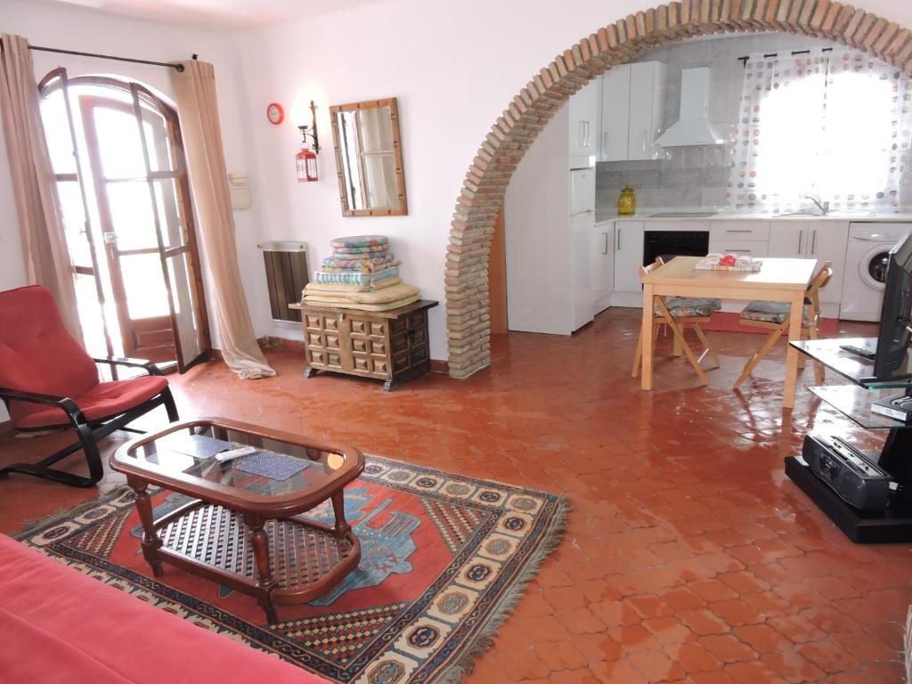 a living room with an archway and a table at Nerja Villas-Capistrano in Nerja