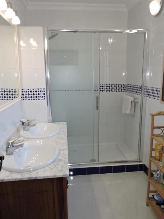 a bathroom with two sinks and a shower at Nerja Villas-Capistrano in Nerja