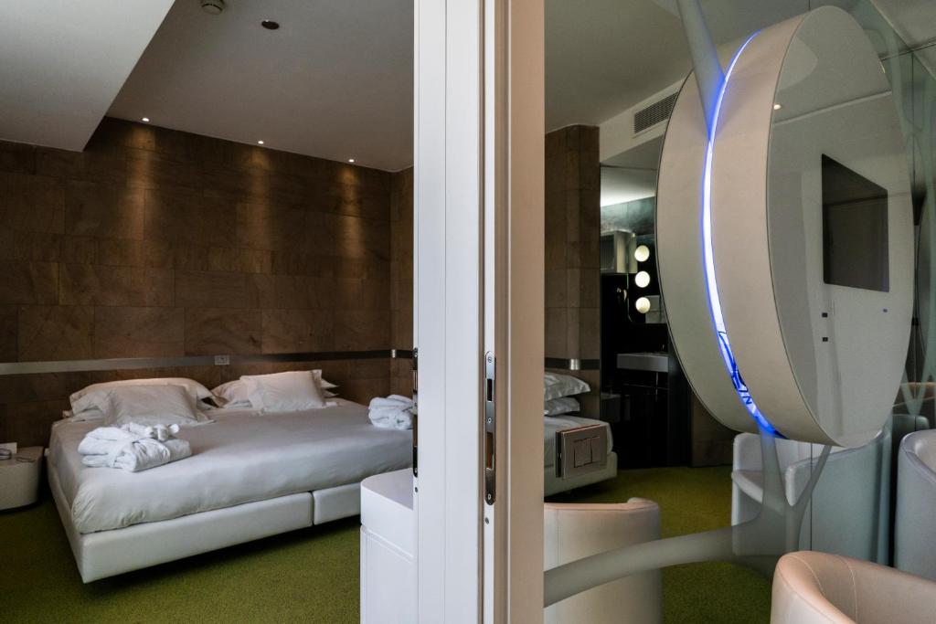 Postel nebo postele na pokoji v ubytování A Point Arezzo Park Hotel