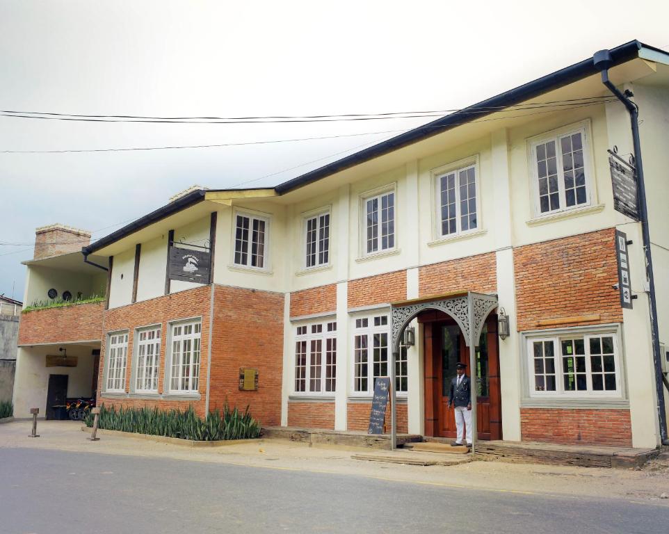 a man standing in front of a building at Railway Lodge Hostel in Hatton