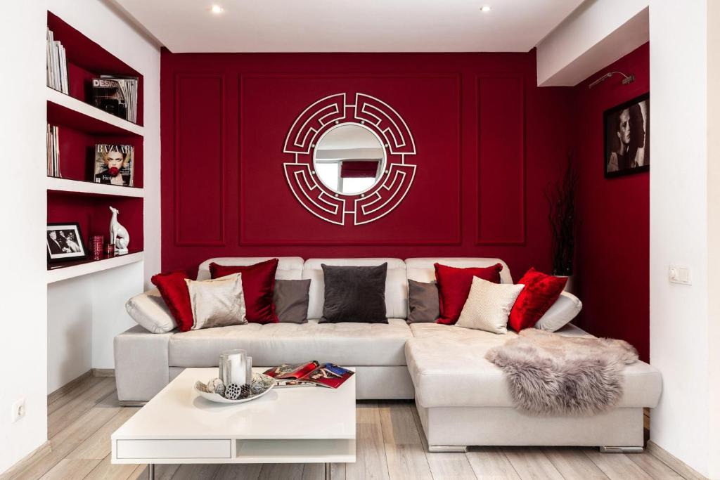 a living room with red walls and a white couch at Qult - Old City Pearl in Bucharest