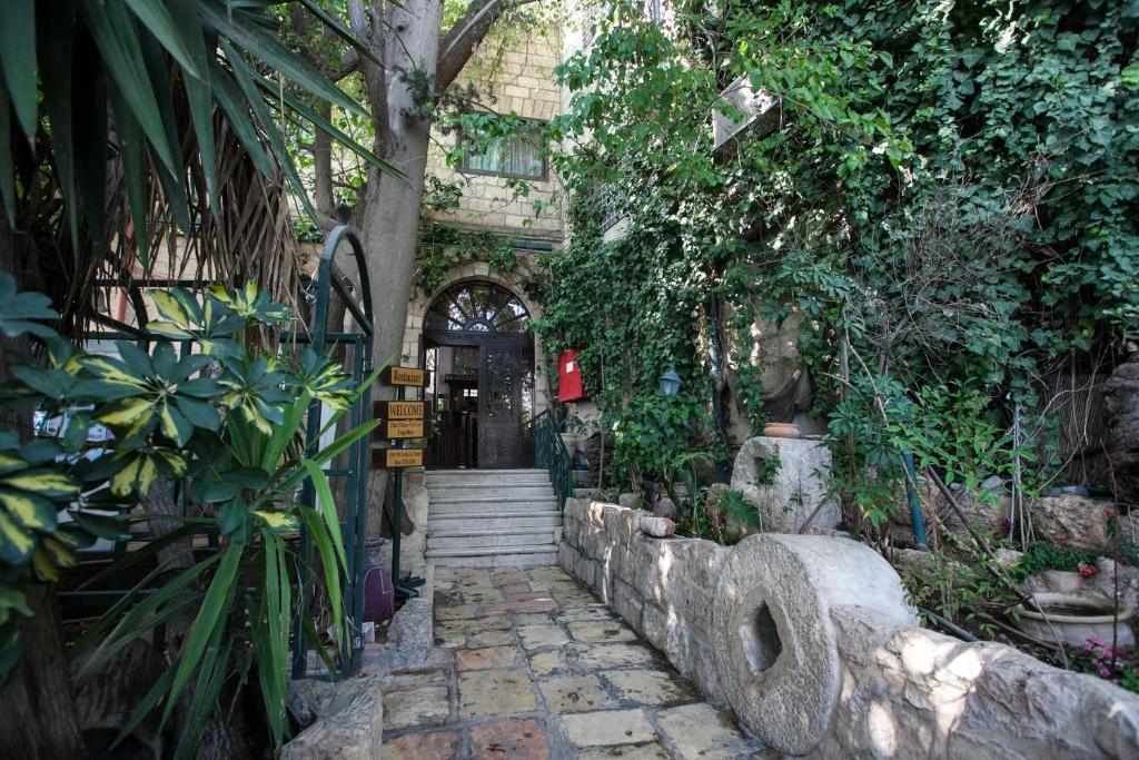 an entrance to a building with a door and plants at Jerusalem Hotel in Jerusalem