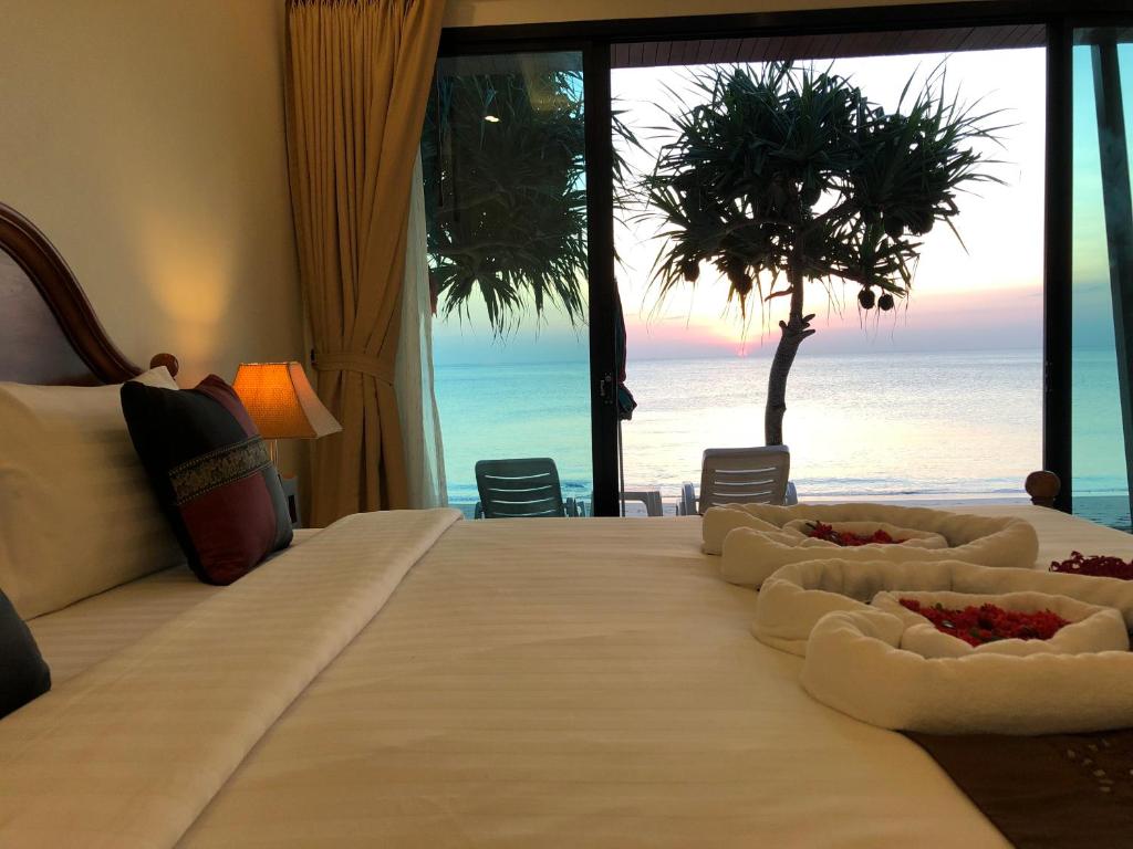 a bedroom with a bed with a view of the ocean at Lanta Seafront Resort in Ko Lanta