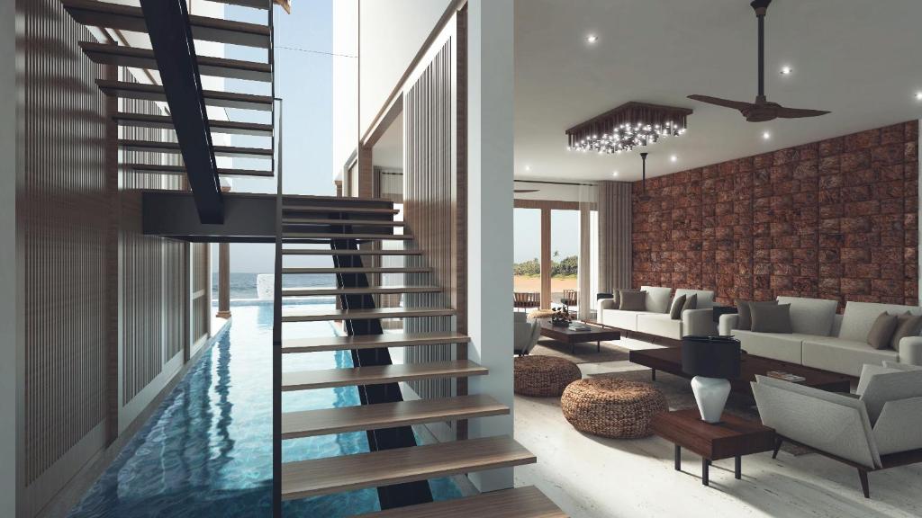 uma sala de estar com uma escada que leva a uma piscina em Villa Blu em Tangalle