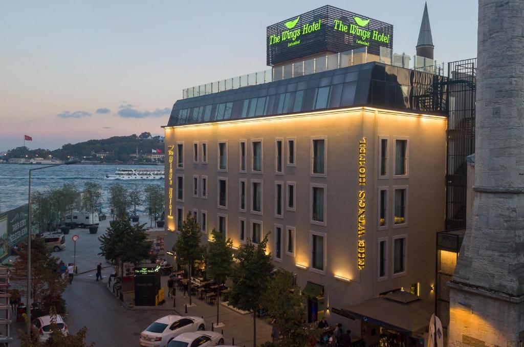 a white building with a sign on top of it at The Wings Hotel Istanbul in Istanbul