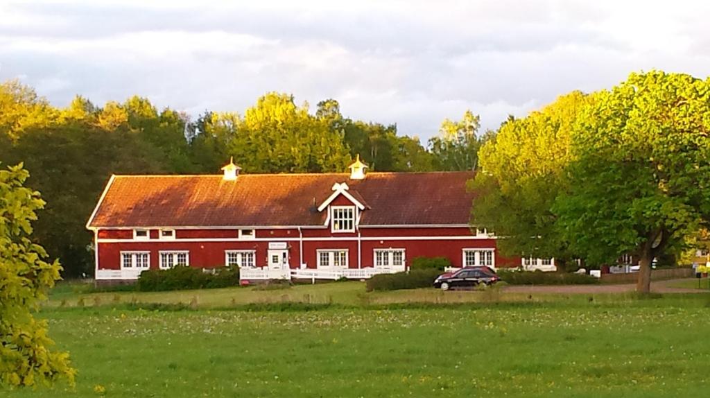 a house with a clock on the front of it at Röda Stallet Bed & Breakfast in Hjo