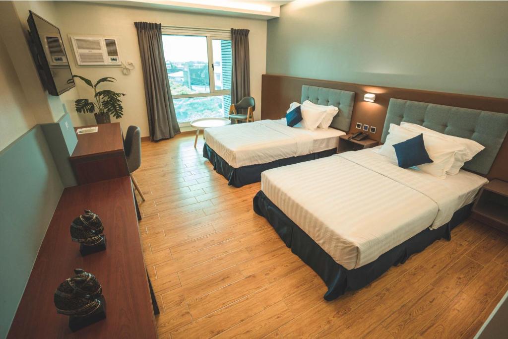 Postel nebo postele na pokoji v ubytování Henia Hotel