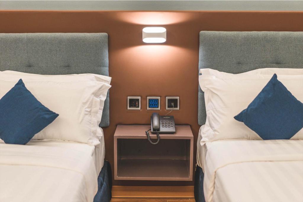 Postel nebo postele na pokoji v ubytování Henia Hotel