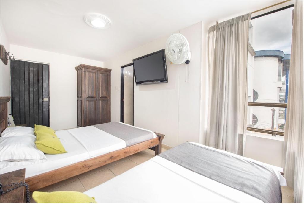 Postel nebo postele na pokoji v ubytování Ayenda 1120 Hotel Comercial