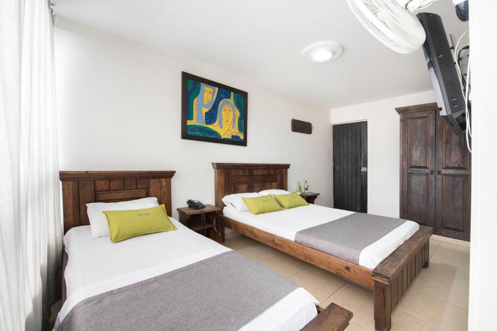 Postel nebo postele na pokoji v ubytování Ayenda 1120 Hotel Comercial