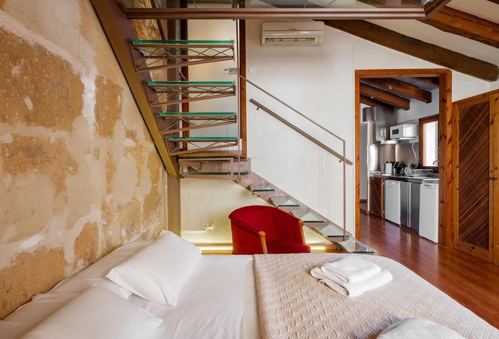 a bedroom with a bed and a stair case at Ramón Llull House in Palma de Mallorca