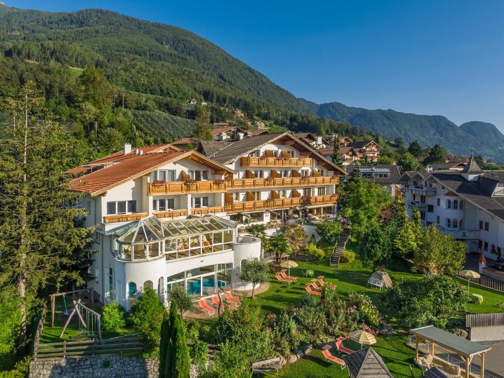 an aerial view of a hotel with mountains in the background at Family Hotel Gutenberg in Schenna