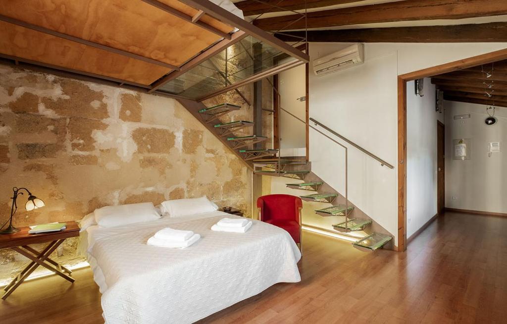 a bedroom with a white bed and a staircase at Ramón Llull House in Palma de Mallorca