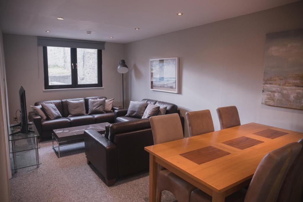 a living room with a couch and a table at Townhouse on the Spital in Aberdeen