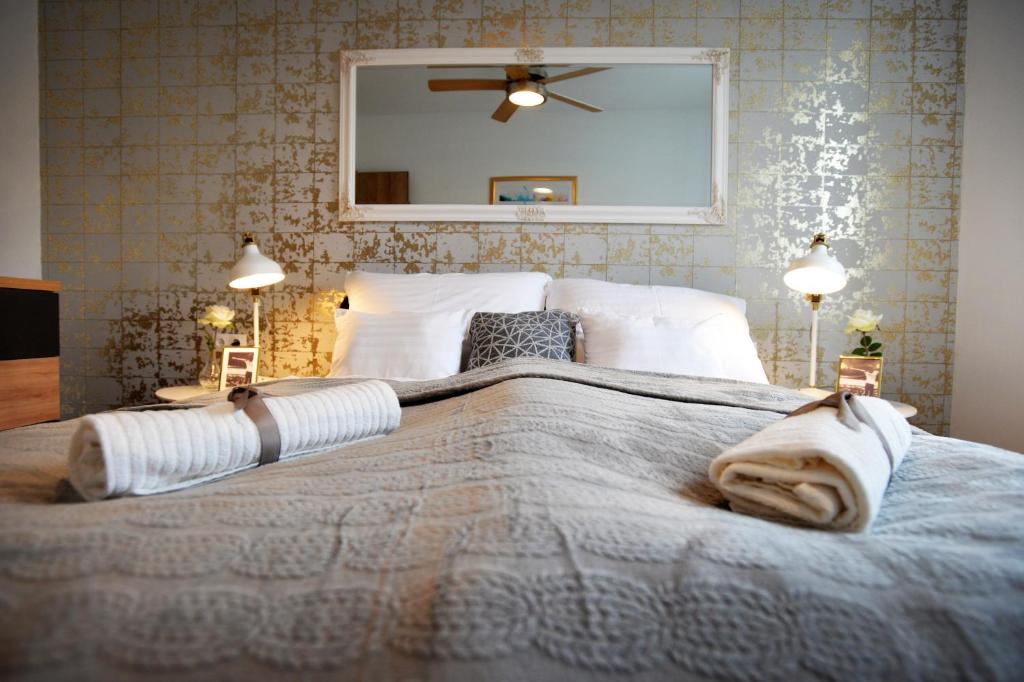 een slaapkamer met een groot bed met 2 lampen bij ONE Luxury Suites Eger in Eger