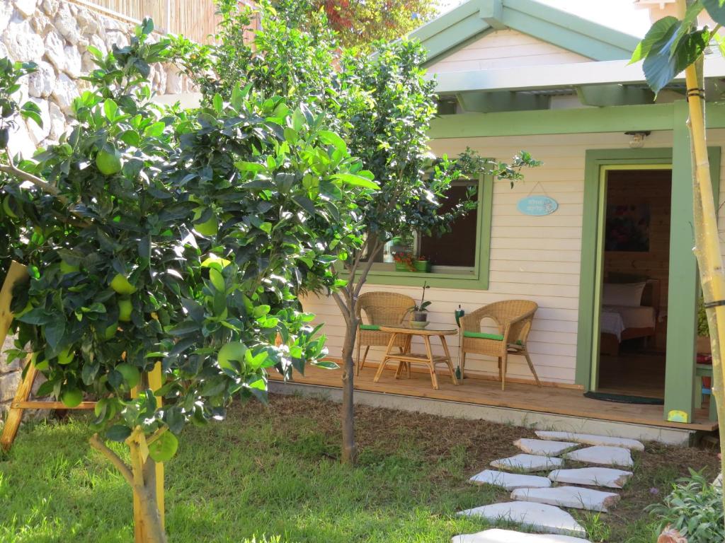 una veranda di una casa con tavolo e sedie di Anat's Cabin הצימר של ענת a Kefar H̱ananya