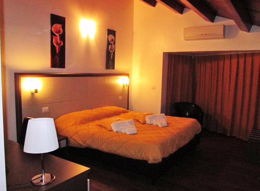 a bedroom with a bed with two pillows on it at B&B Elisir in Gela