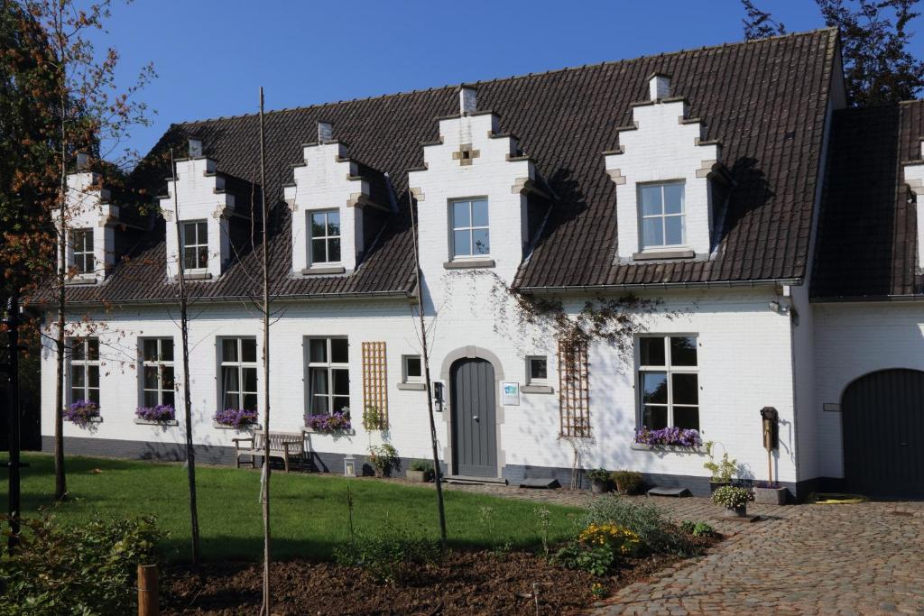 Biały dom z czarnym dachem w obiekcie Villa Helena w mieście Linden