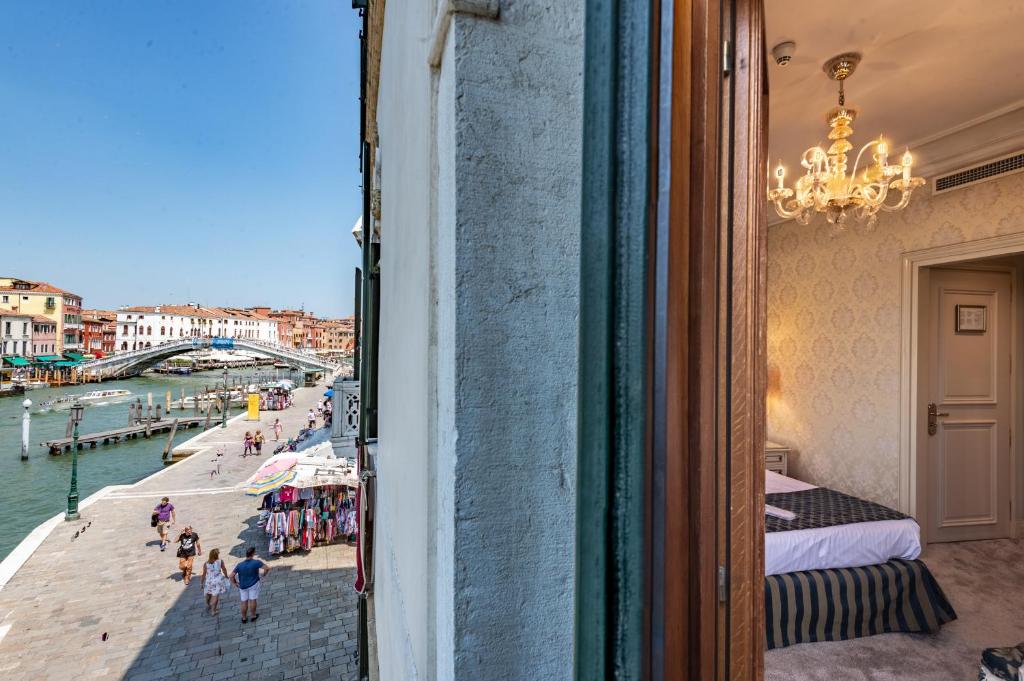 a window of a building with a view of a river at Hotel Antiche Figure in Venice
