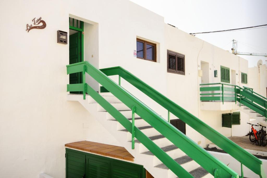 a staircase in a building with green railings at Los Topes in Puerto del Carmen