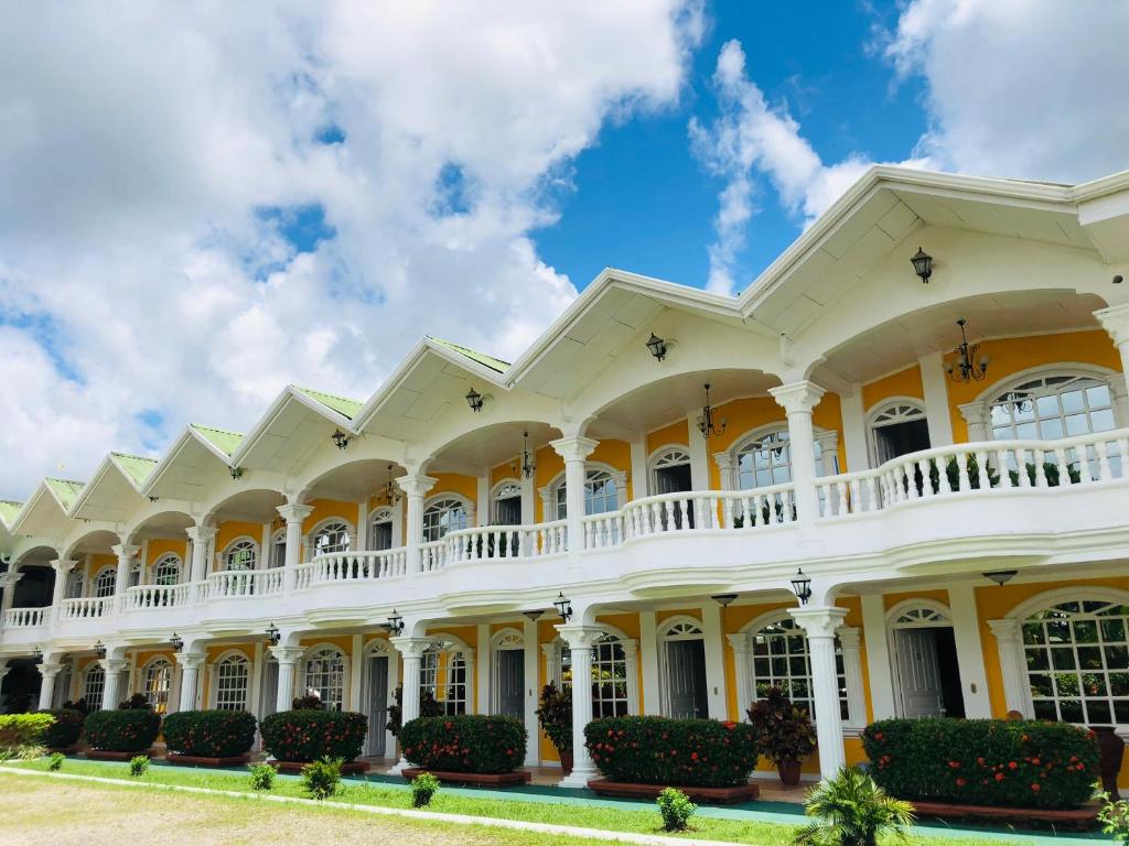 a large white building with a balcony at Hotel Andrea in Neily