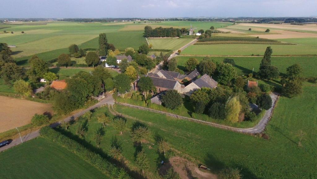 an aerial view of a house in a green field at b&b Het Wolfshuis in Bemelen