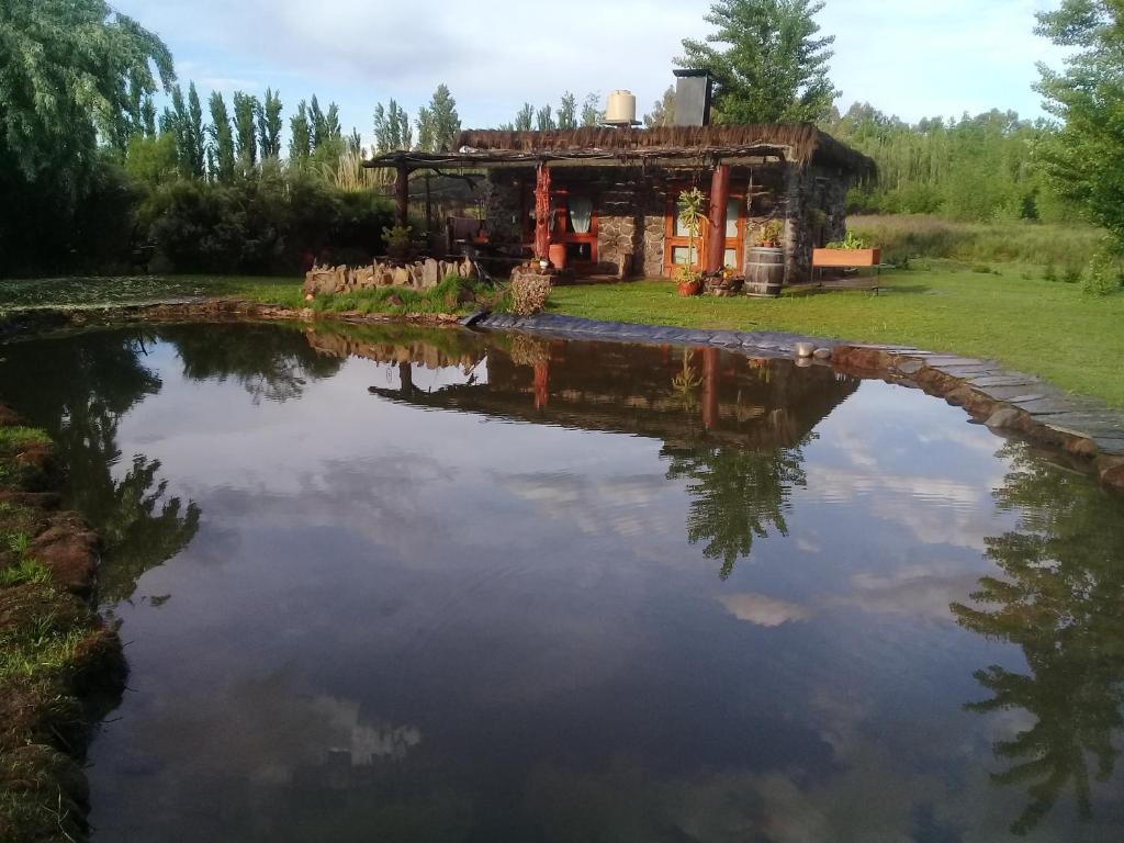 a large pond in front of a house at Hogar de Campo in San Rafael